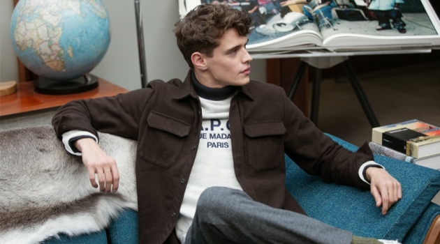 Relaxing, Jordy Baan sports an A.P.C. shirt jacket, Champion sweatshirt, Club Monaco houndstooth trousers, and Onitsuka Tiger California 78 EX sneakers.