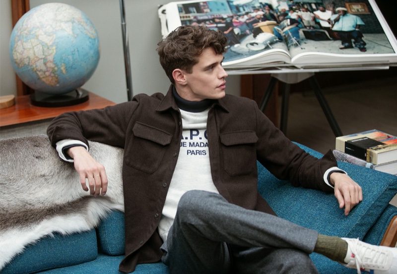 Relaxing, Jordy Baan sports an A.P.C. shirt jacket, Champion sweatshirt, Club Monaco houndstooth trousers, and Onitsuka Tiger California 78 EX sneakers.