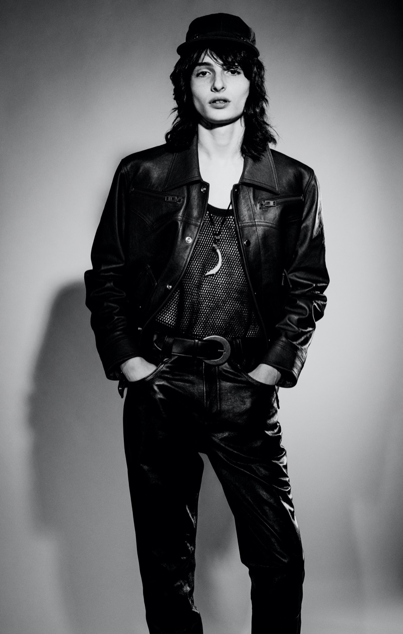 Actor Finn Wolfhard sports a leather jacket and pants with a tank from Coach 1941. He also dons a Saint Laurent belt.