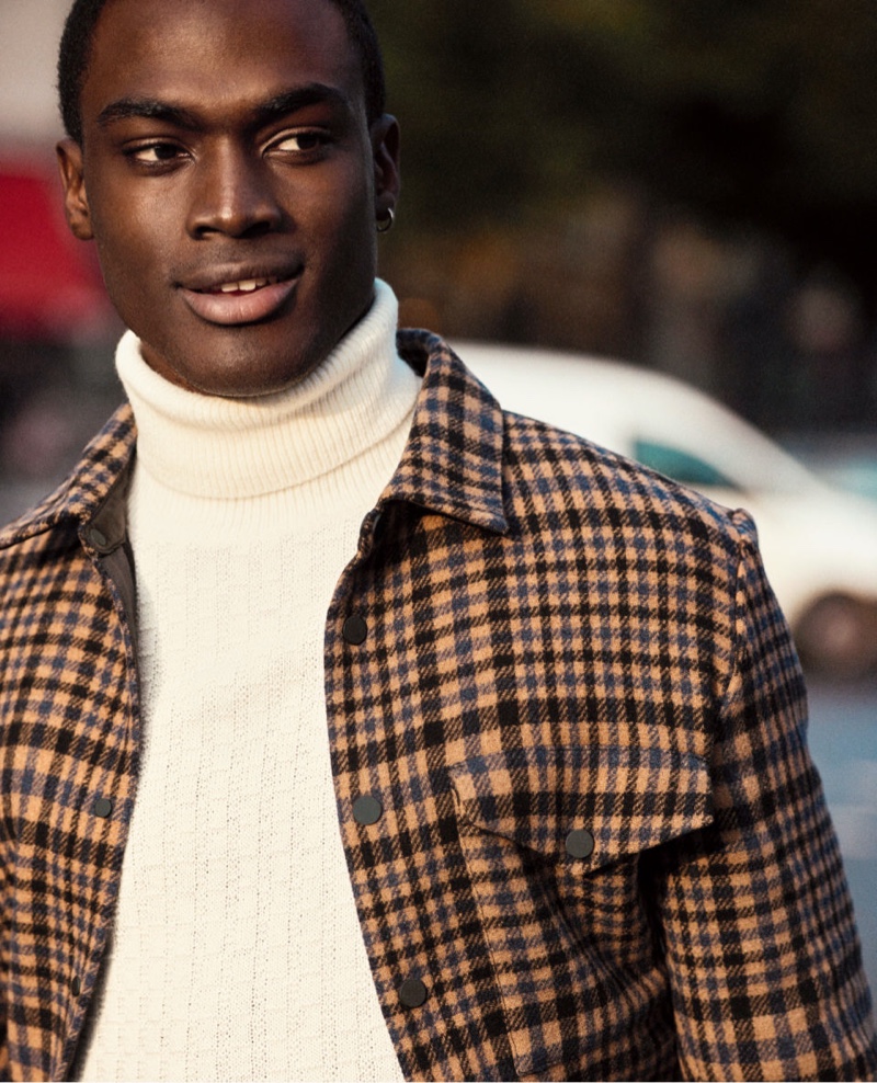 Davidson Obennebo dons a turtleneck sweater with a checked jacket by H&M.