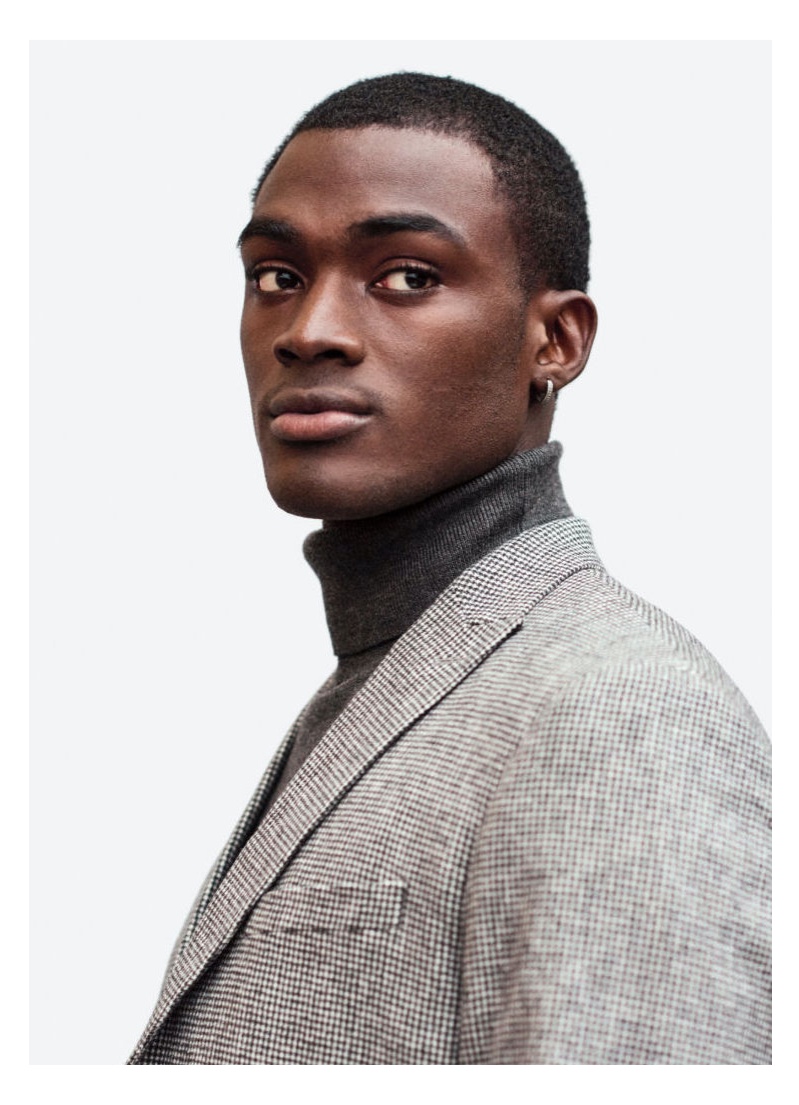 A smart vision, Davidson Obennebo wears a turtleneck with a checked suit jacket from H&M.