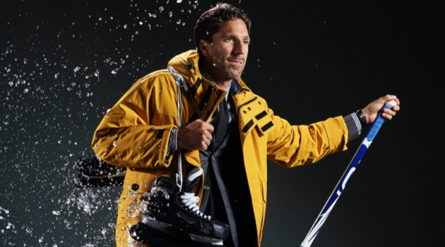 Henrik Lundqvist Sports Winter Outerwear for Men's Health Connecting with Men's Health, Henrik Lundqvist sports a BOSS down jacket, suit jacket, shirt, and tie. Velient Align MX pants, Timberland sneaker boots, and a TAG Heuer watch complete his look.