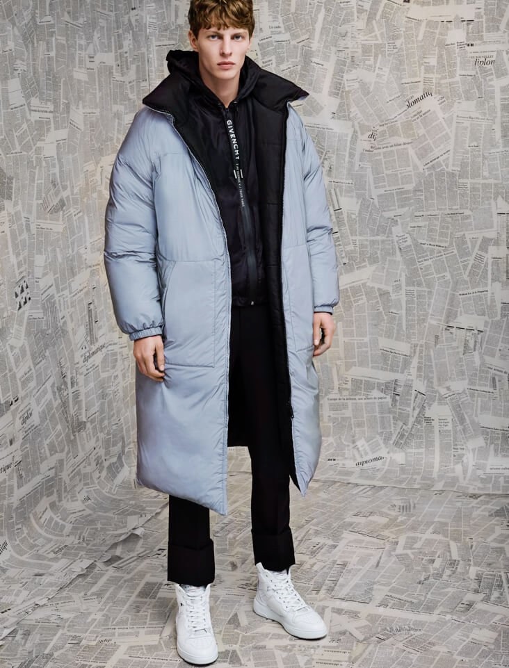 Front and center, Tim Schuhmacher models a Givenchy puffer jacket with trousers and high-top sneakers.