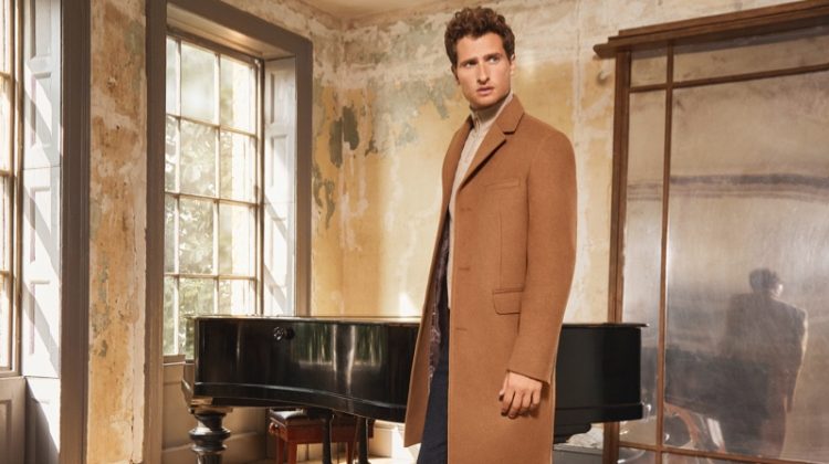 Tom Warren dons a classic camel coat for Jaeger's fall-winter 2019 campaign.