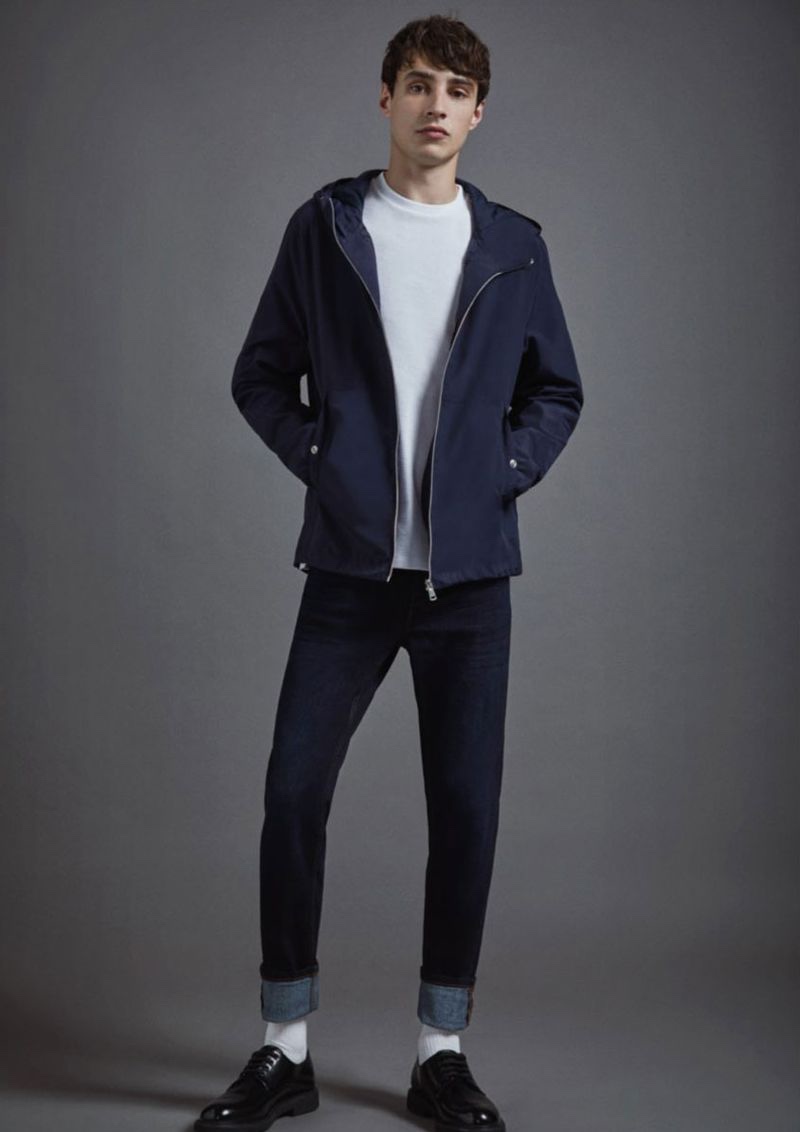 Taking to the studios, Adrien Sahores dons a navy hooded jacket and blue jeans from Lefties. 