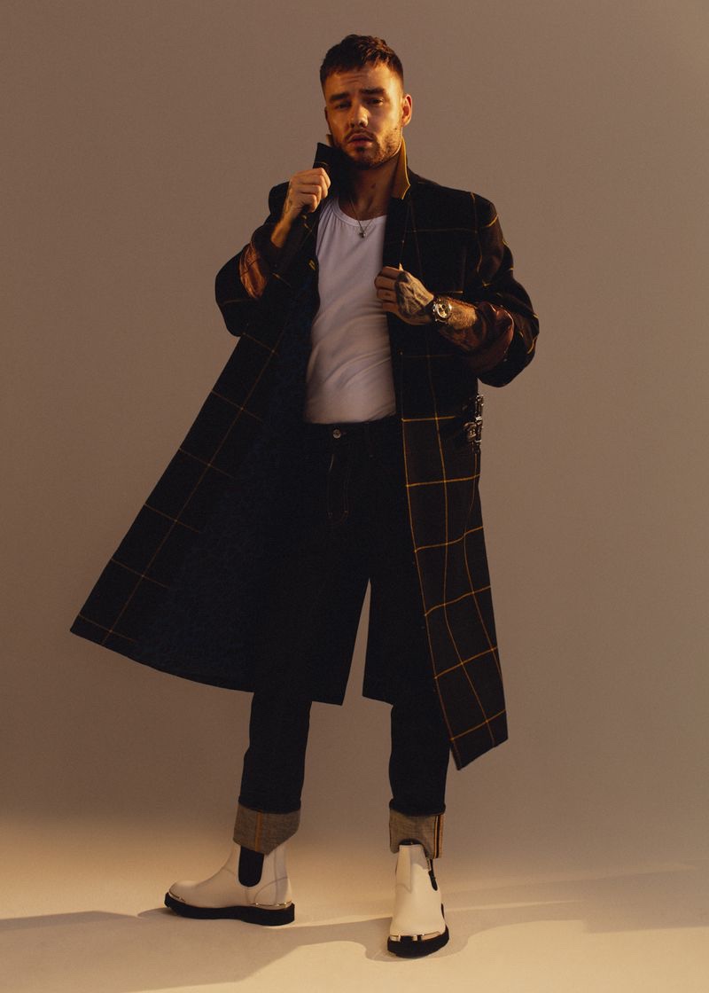 Liam Payne dons a Paul Smith coat, Versace shirt, Dsquared2 jeans, Lanvin boots, and a Rolex watch for the pages of Têtu.