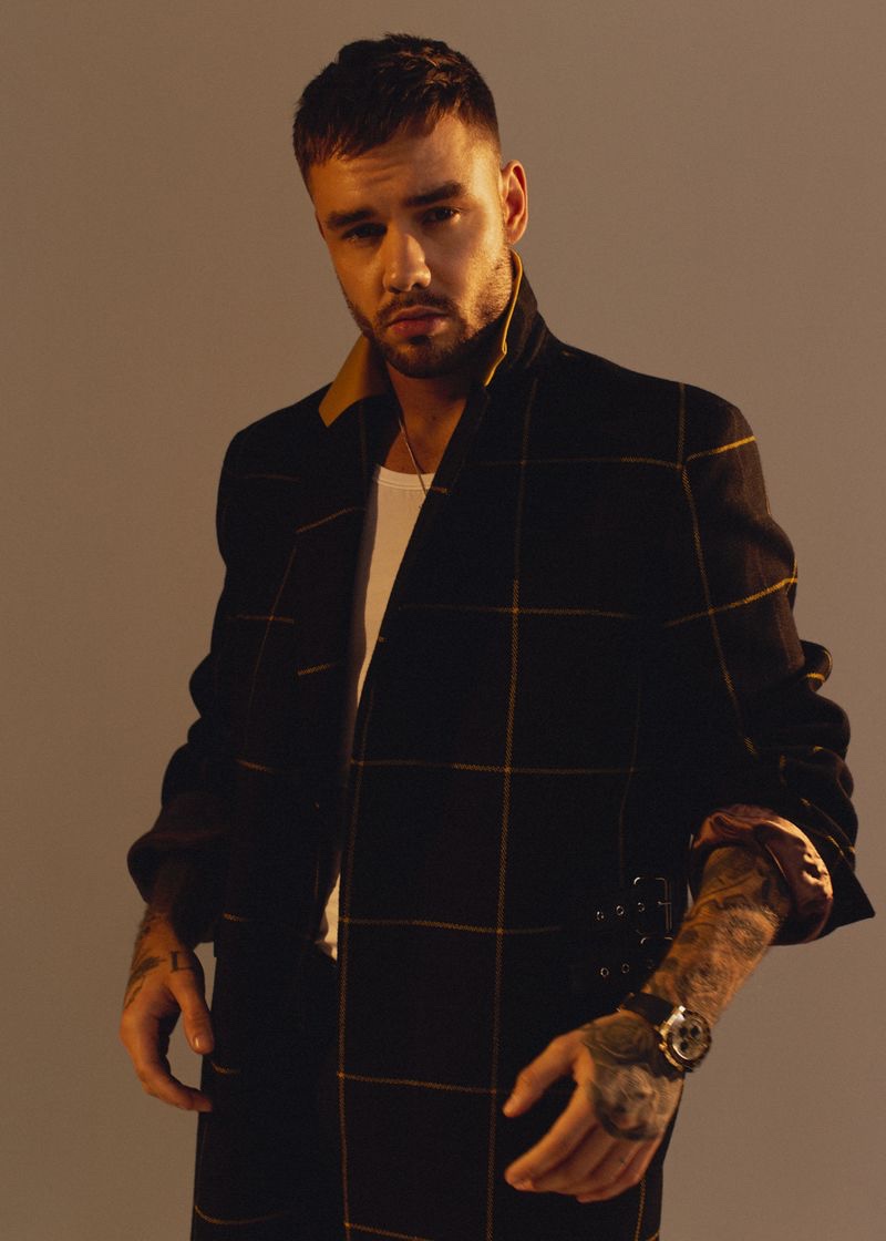 Singer Liam Payne sports a Paul Smith coat with a Versace shirt for Têtu.