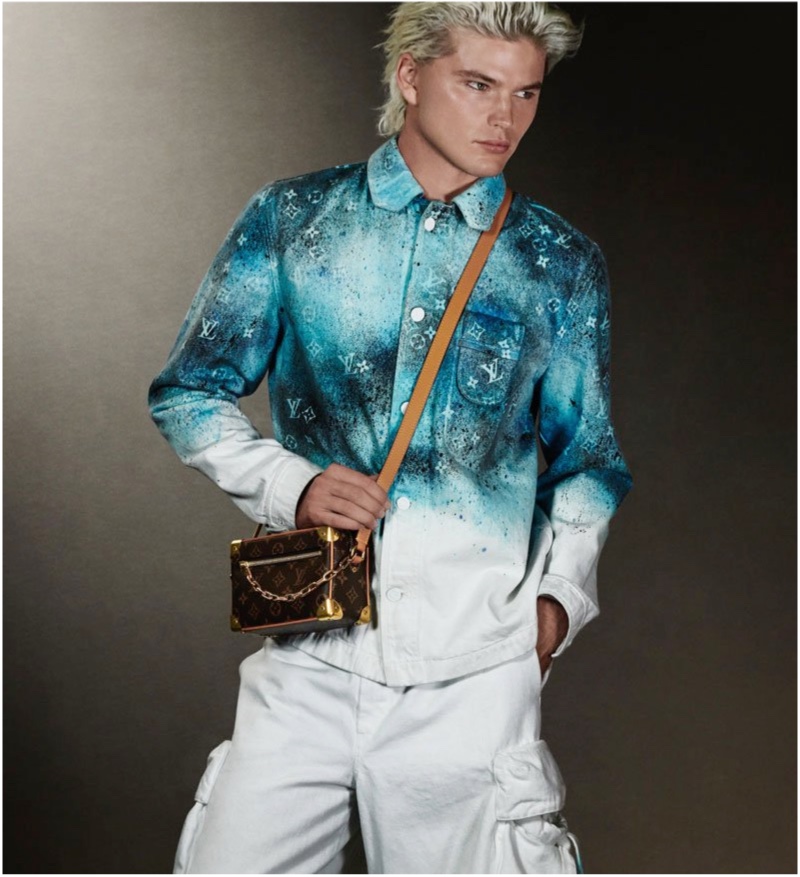 Jordan Barrett sports a workwear shirt and denim cargo pants from Louis Vuitton's pre-spring 2020 collection.