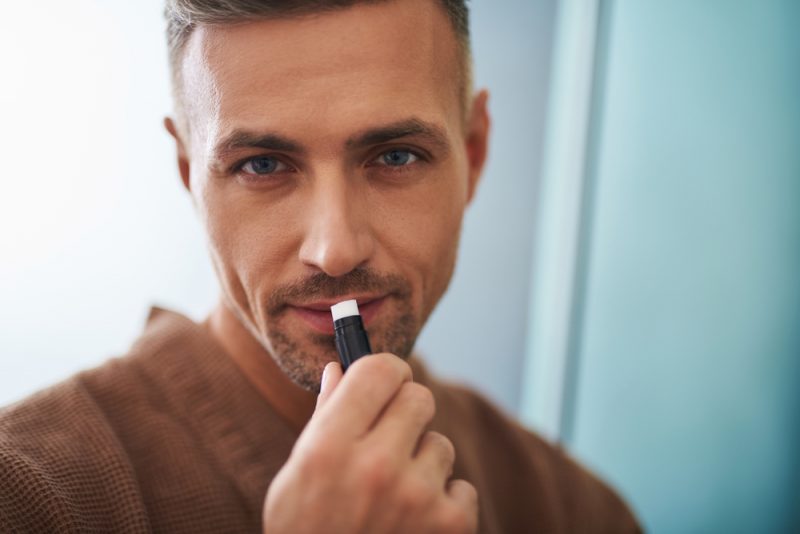 Man Putting on Lip Balm