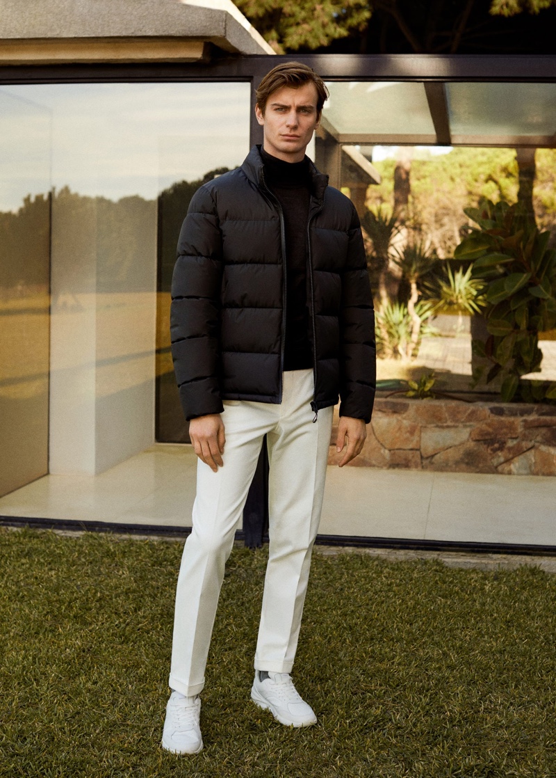 Ben Allen sports a black puffer jacket with pleated pants by Mango.