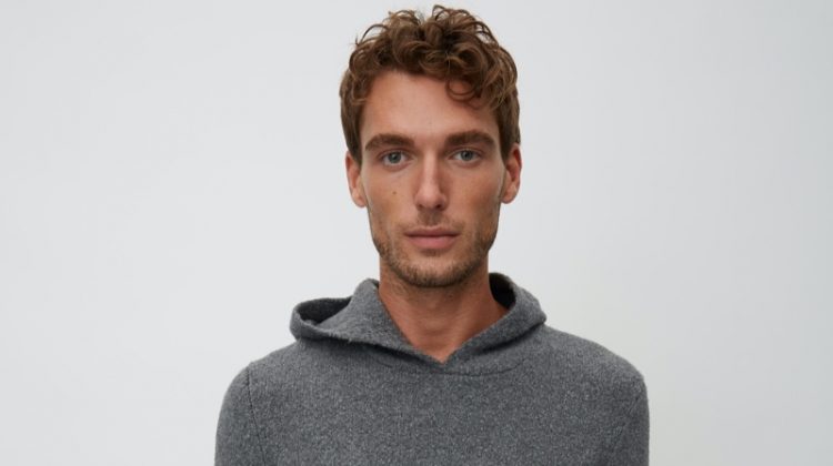 Nikola Jovanovic wears a grey hooded knit from Marc O'Polo's Christmas collection.