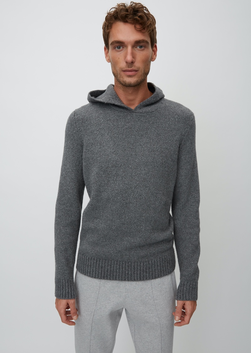 Nikola Jovanovic wears a grey hooded knit from Marc O'Polo's Christmas collection.