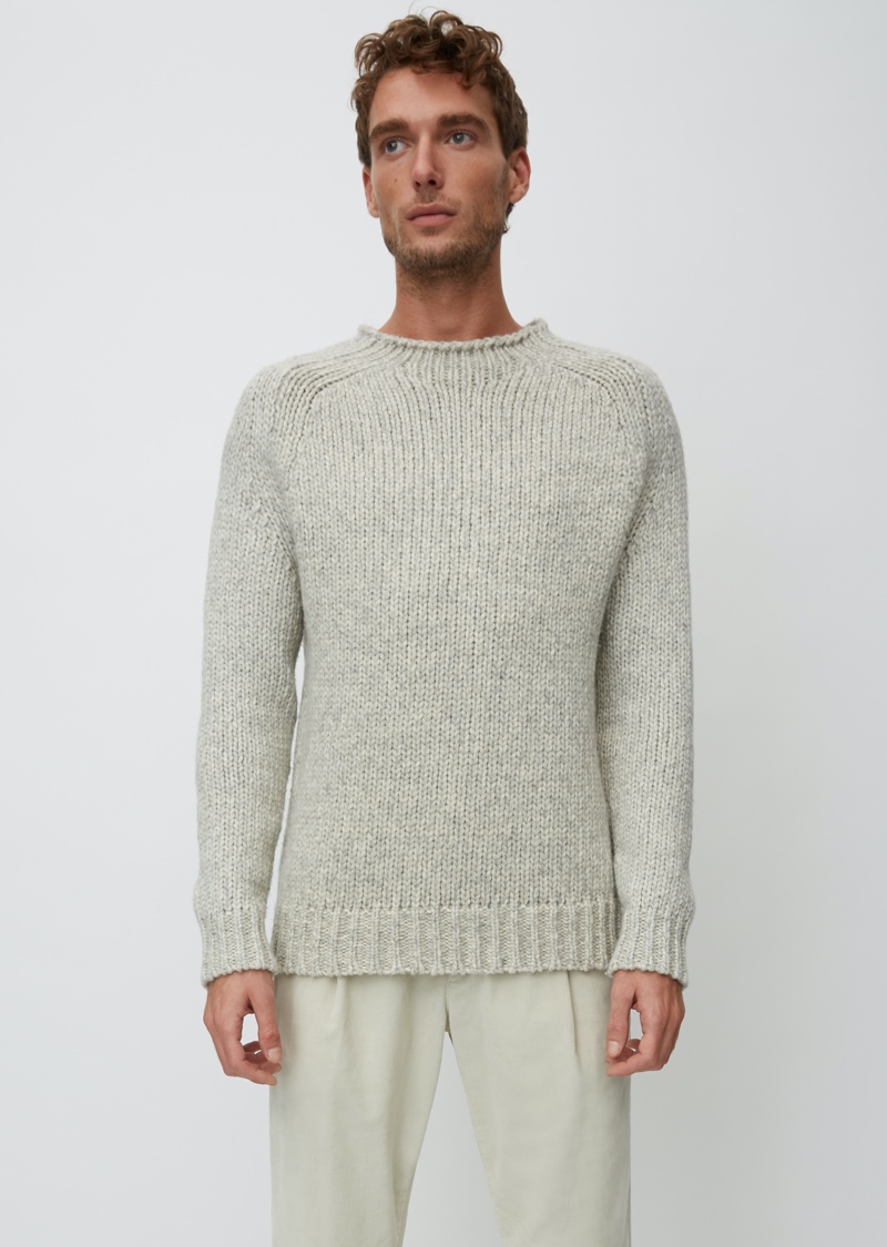 Embracing neutrals, Nikola Jovanovic dons a sweater from Marc O'Polo's Christmas collection.