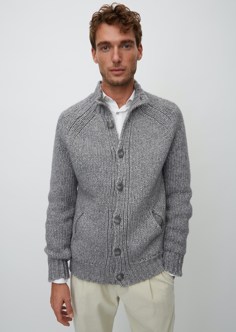 A smart vision, Nikola Jovanovic models a grey cardigan sweater from Marc O'Polo's Christmas collection.