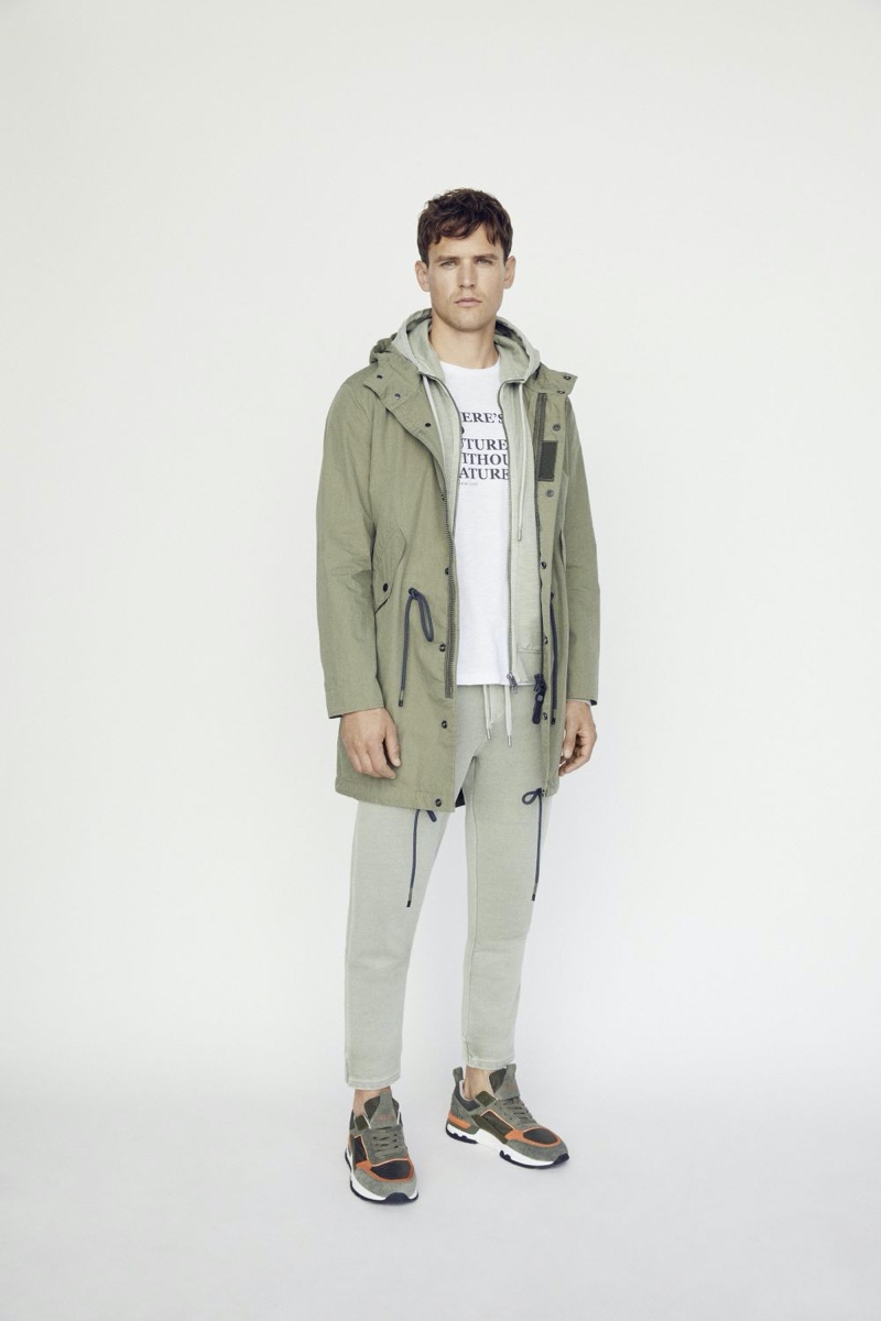 Donning neutrals, Guy Robinson layers in a hoodie and parka from Marc O'Polo.