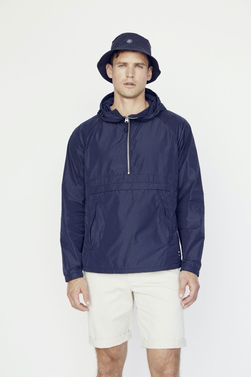 British model Guy Robinson sports a windbreaker with shorts and a bucket hat from Marc O'Polo.