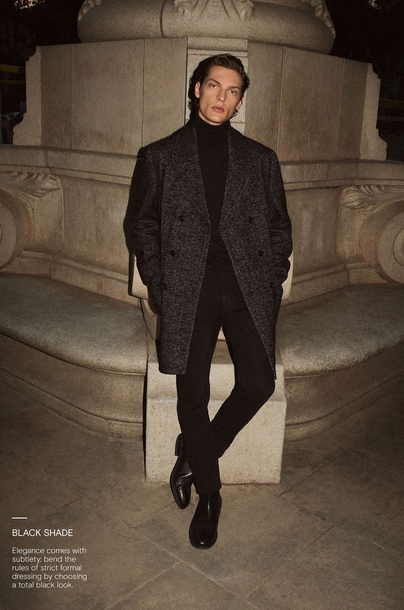 Valentin Caron dons a herringbone coat and turtleneck with boots from Massimo Dutti.