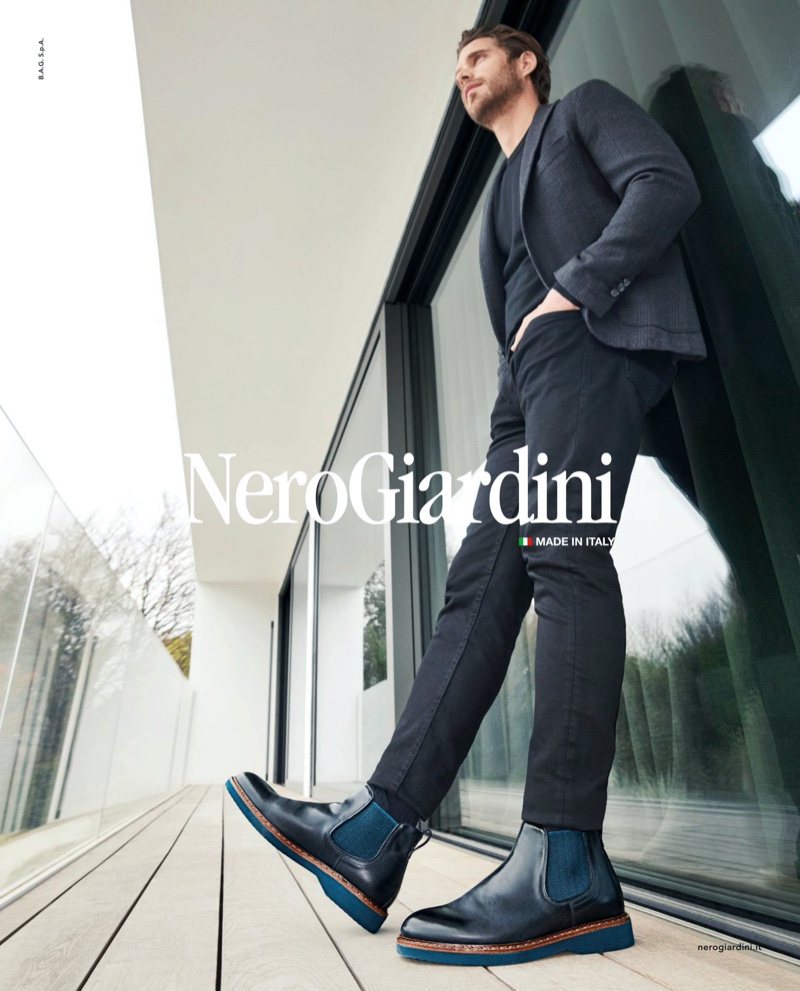 A sleek vision, Simone Bredariol wears black and blue boots for Nero Giardini's fall-winter 2019 campaign.