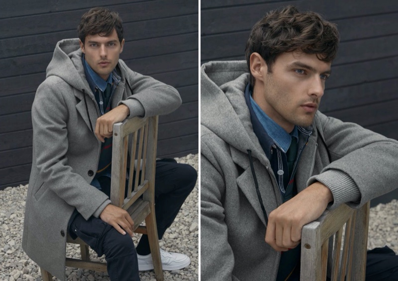 Model Hannes Gobeyn sports a LE 31 hooded overcoat in grey.