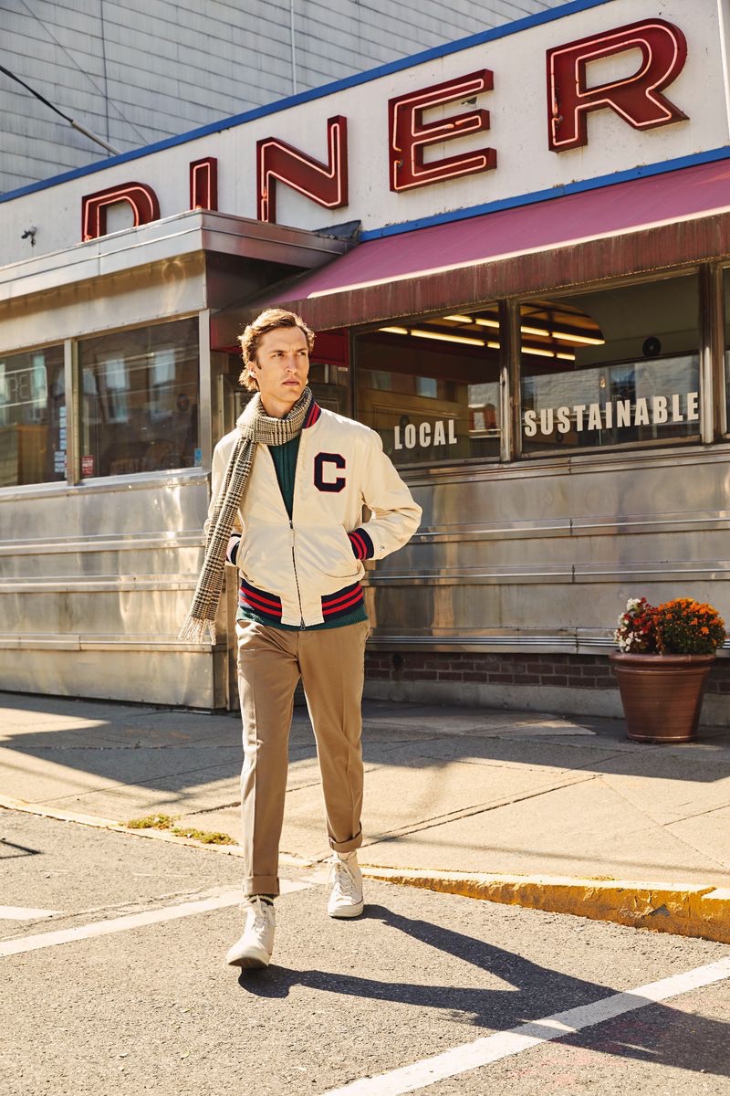 Embracing collegiate style, Tim Dibble dons a Todd Snyder + Champion winged foot Goldenbear bomber jacket $498, Todd Snyder Italian ribbed sweater $268, and a Drake's glen check merino wool scarf $172.