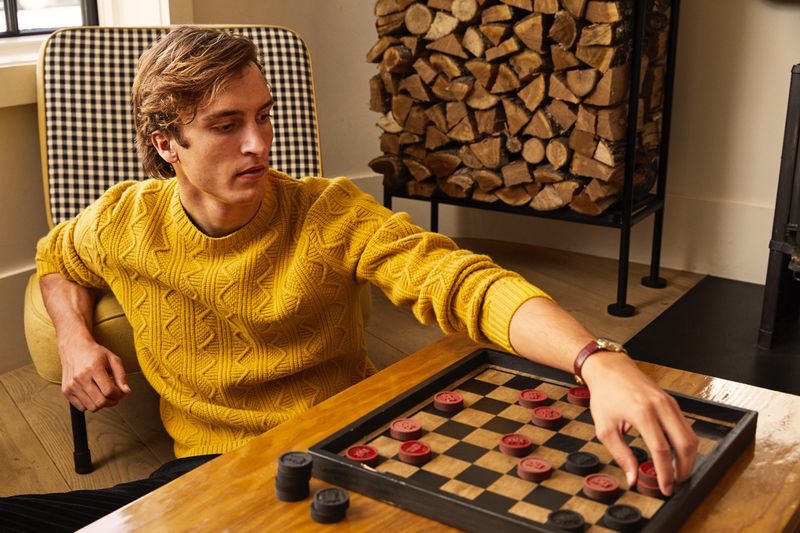 Making a case for color, Tim Dibble dons a yellow merino cable-knit sweater $278 from Todd Snyder.