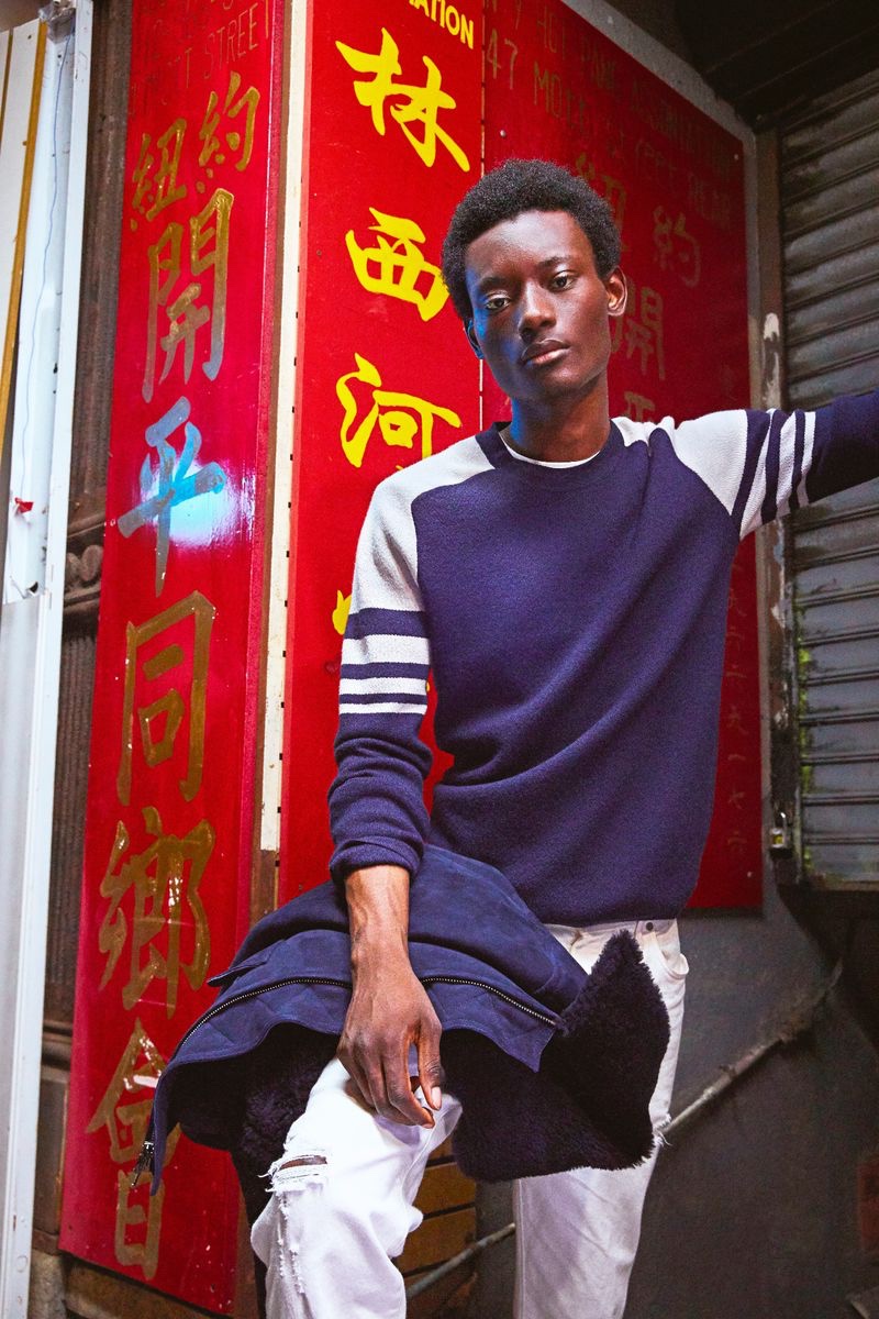 Youssouf Bamba rocks a Todd Snyder merino ski sweater in navy.