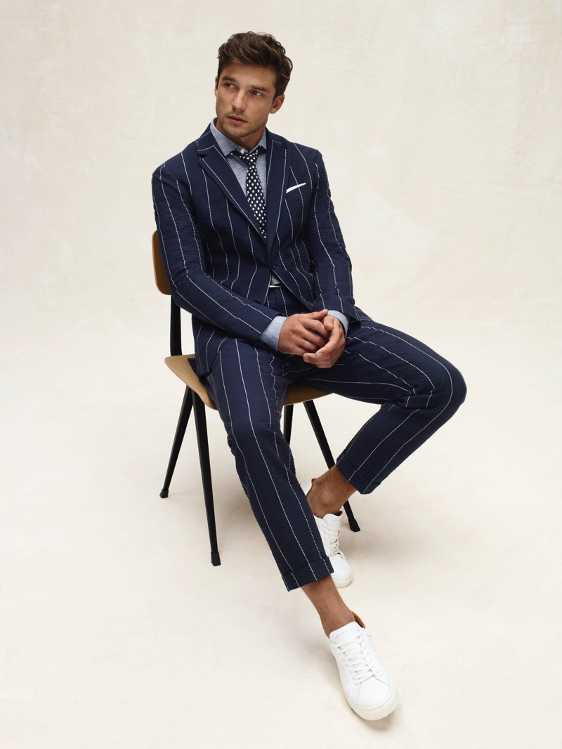 French model Alexis Petit dons a pinstriped suit from Tommy Hilfiger's spring-summer 2020 collection.