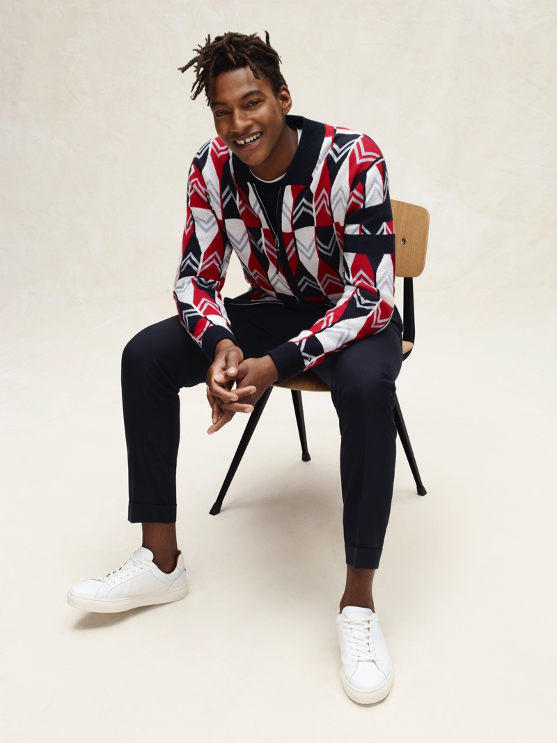 Ty Ogunkoya dons a half-zip graphic pullover from Tommy Hilfiger's spring-summer 2020 collection.