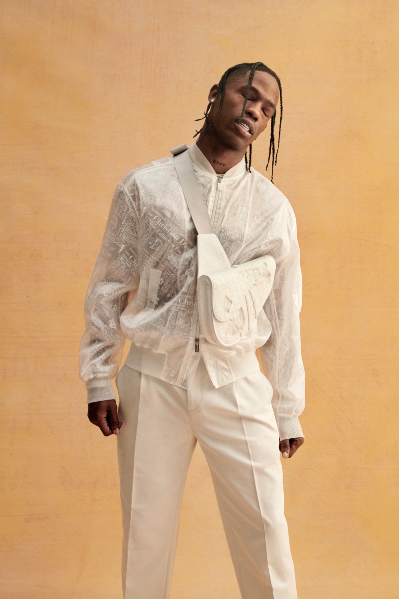 Dressed in white, Travis Scott sports Dior Men.