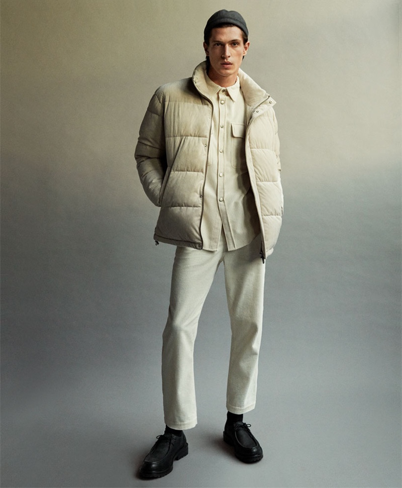 Embracing a neutral color palette, Edoardo Sebastianelli rocks a matching corduroy shirt and pants with a puffer jacket by Zara.