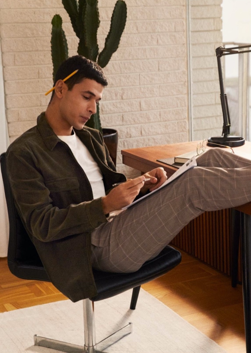 Embracing smart style, Ali Latif wears checked tailored joggers with a shirt jacket from H&M.