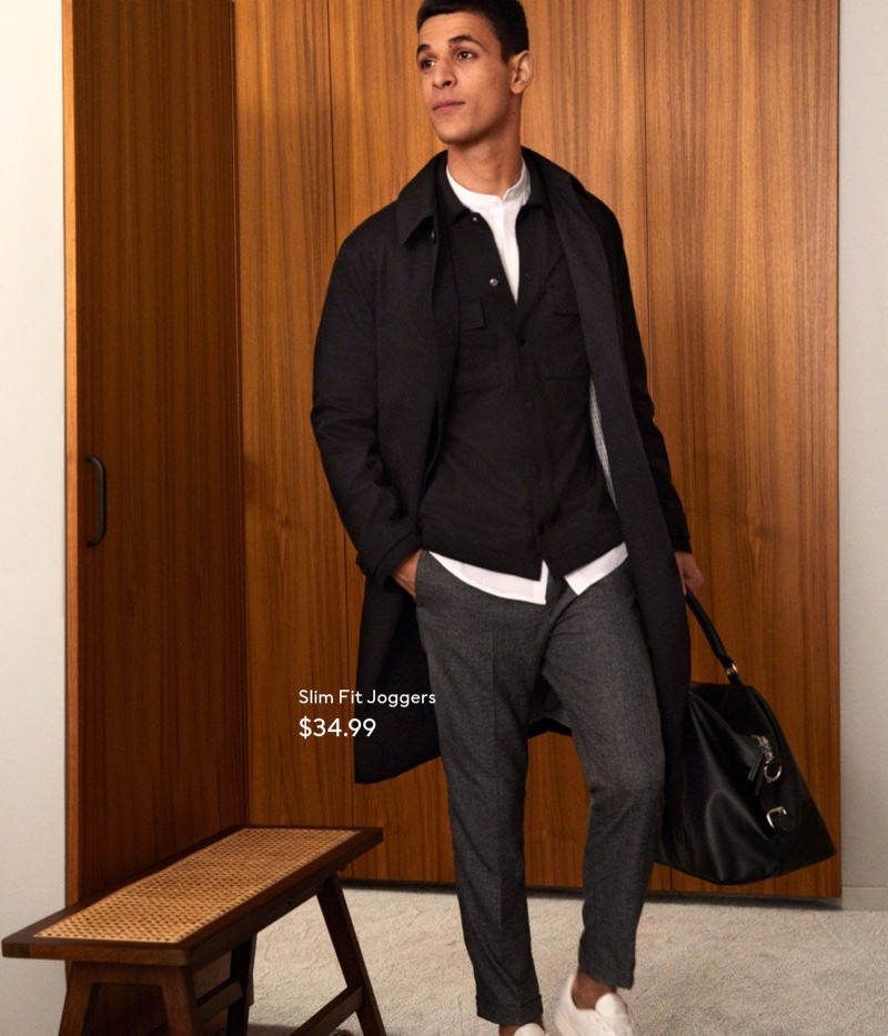 Showcasing smart casual style, Ali Latif is ready to head to the office in tailored joggers from H&M.