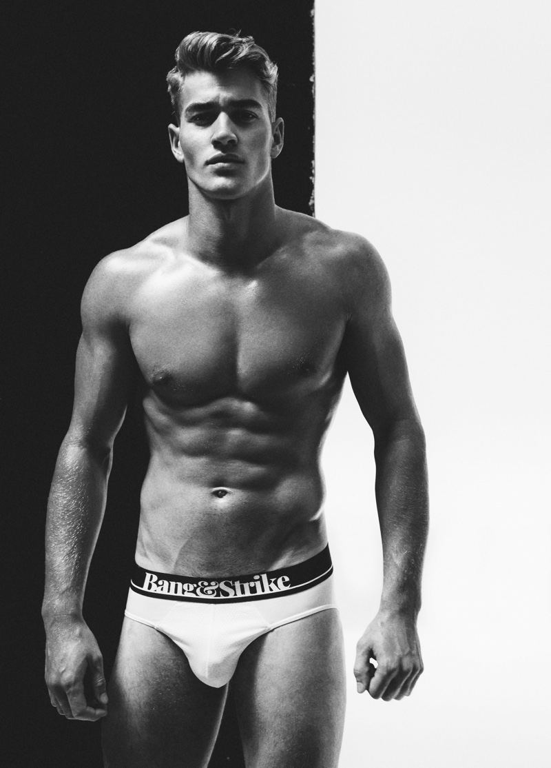 Appearing in a black and white photo, Matty Carrington models Bang & Strike flex sport underwear.