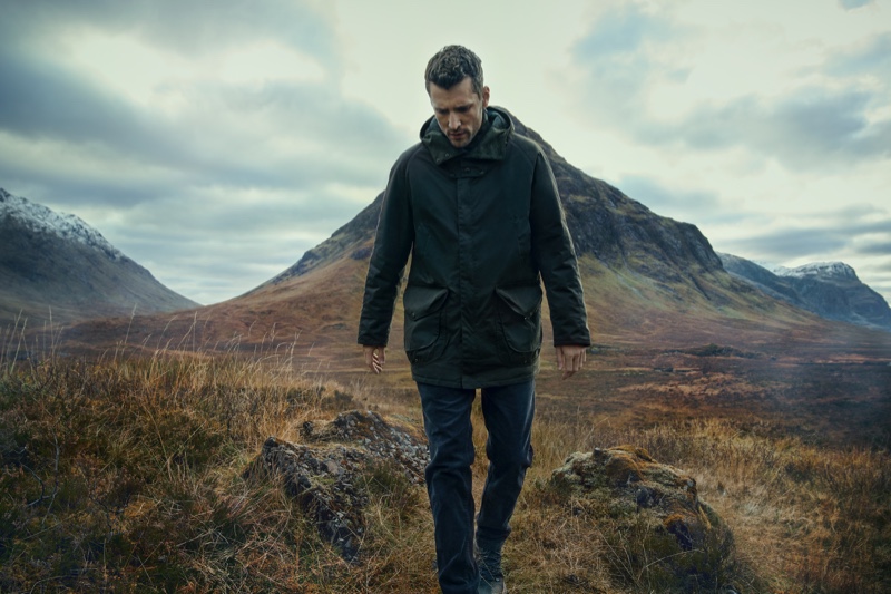 Venturing outdoors, George Barnett dons Barbour Gold Standard's Beaufort Wax jacket.