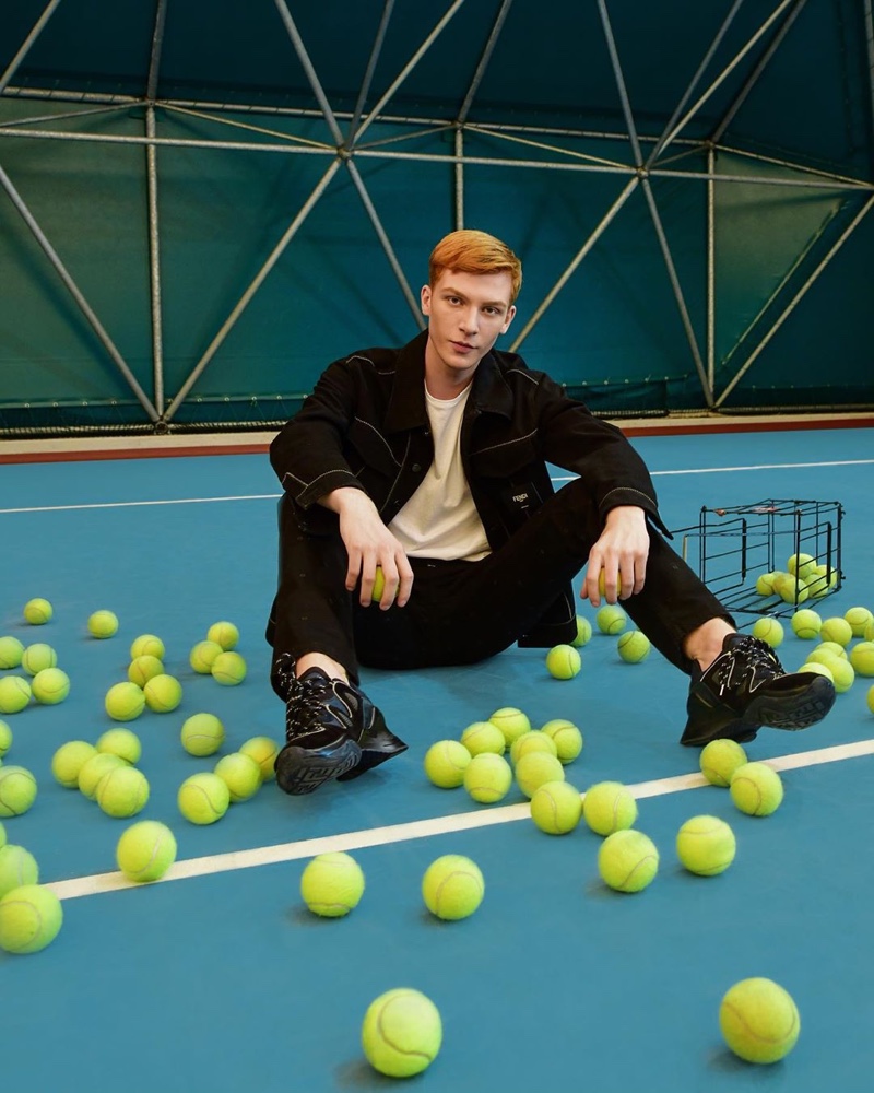 Polish model Simon Gano sports a pair of Fendi FFluid sneakers.