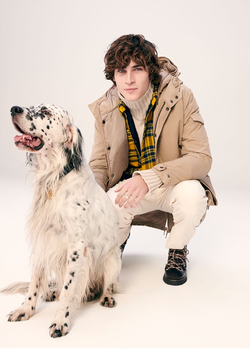 Ready for an outdoors excursion, Liam Kelly layers in a parka and turtleneck sweater.