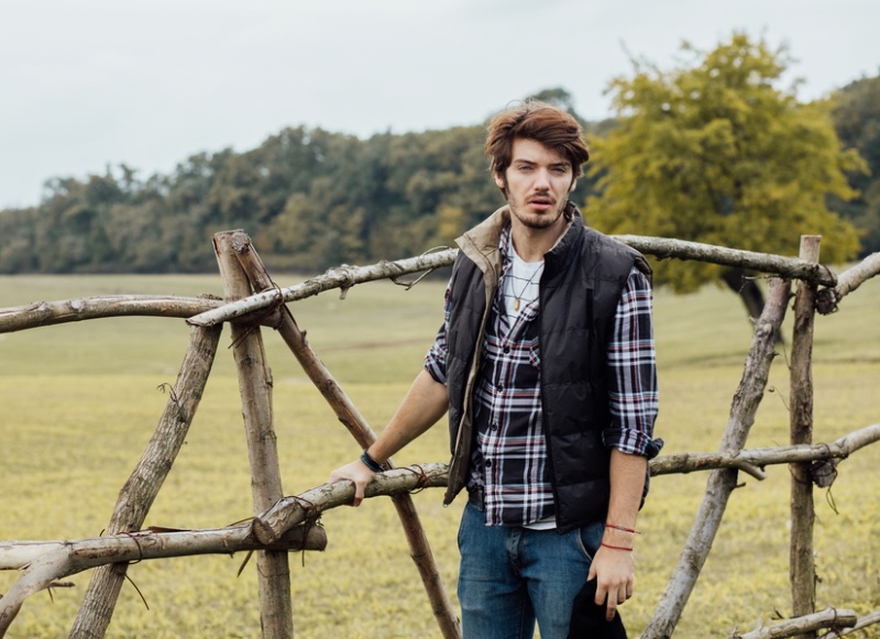 Layer a button-down shirt underneath a quilted vest for rugged style. » 5 Ways to Style Men's Button-Down Shirts Layer a button-down shirt underneath a quilted vest for rugged style.