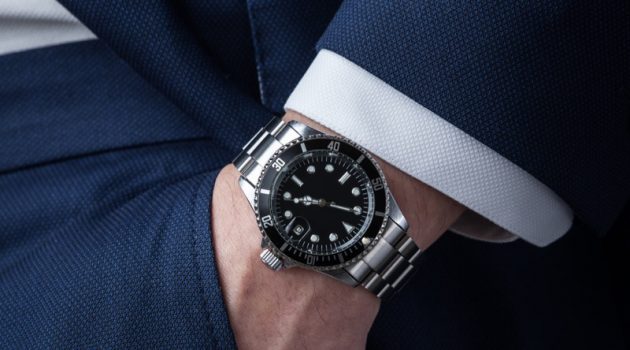 5 Ways to Choose the Pre-Owned Rolex That’s Right For You Man Wearing Silver Rolex Watch Suit Closeup
