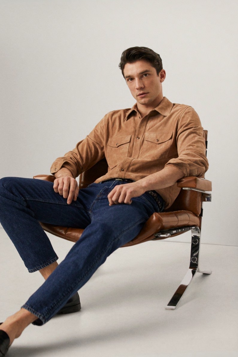 Alexis Petit sports a suede shirt with dark wash denim jeans from Mango's spring-summer 2020 collection.