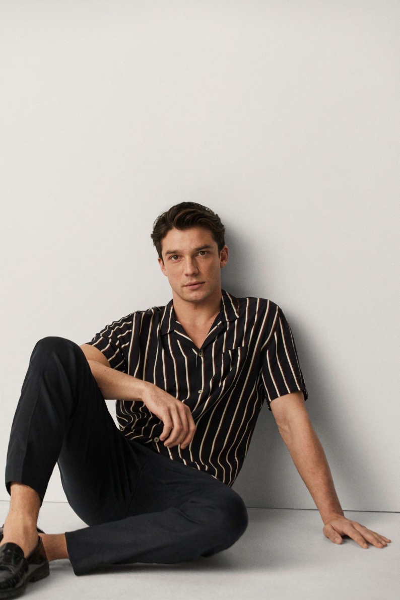 Model Alexis Petit wears a striped short-sleeve shirt with trousers from Mango.