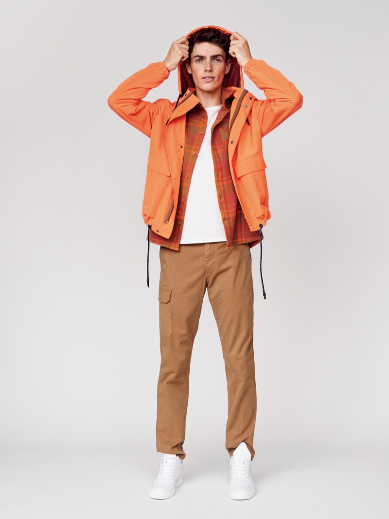 Model Aidan Walsh stands out in orange fashions from Marc O'Polo's spring-summer 2020 collection.