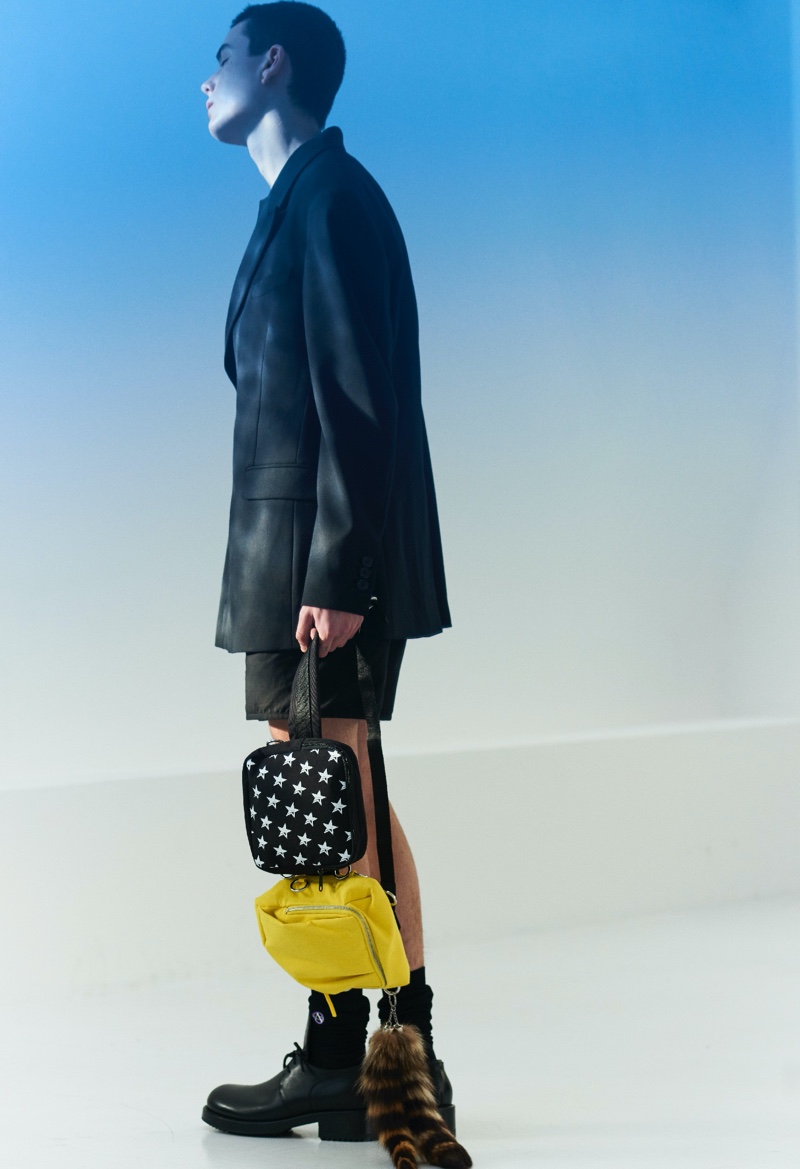 Front and center, Nika Jovanovic takes hold of a belt bag from the Raf Simons x Eastpak spring-summer 2020 collection.