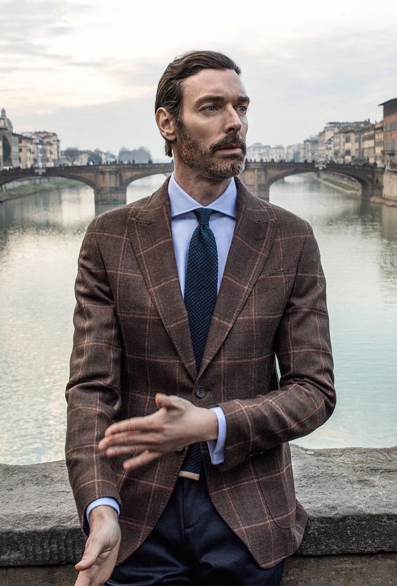 Richard Biedul dons a chic check suit jacket in a natural tone from Massimo Dutti.