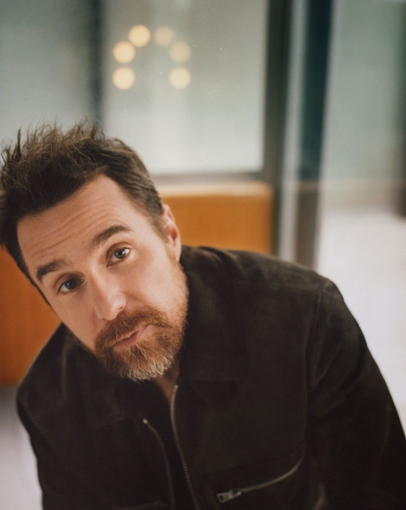Ready for his close-up, Sam Rockwell dons a Tom Ford suede jacket with a John Smedley wool polo shirt.
