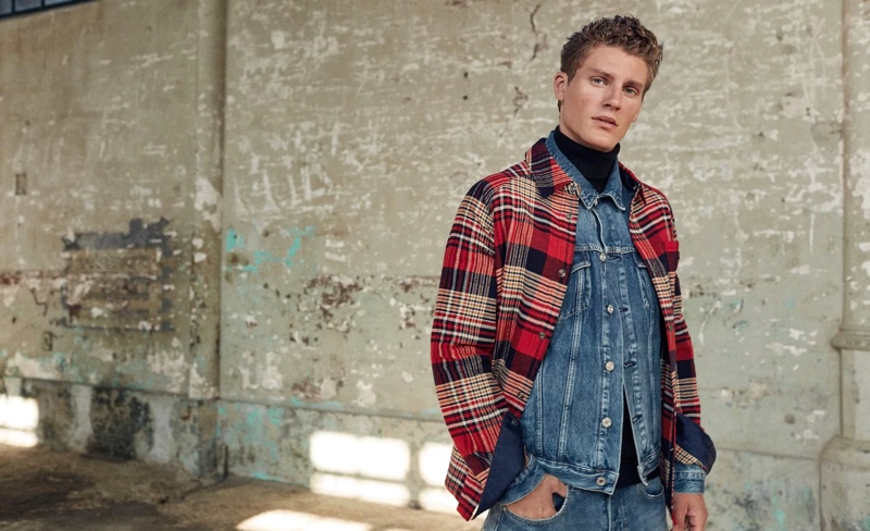 Front and center, Mikkel Jensen doubles down on Scotch & Soda denim. He completes his look with a plaid overshirt.