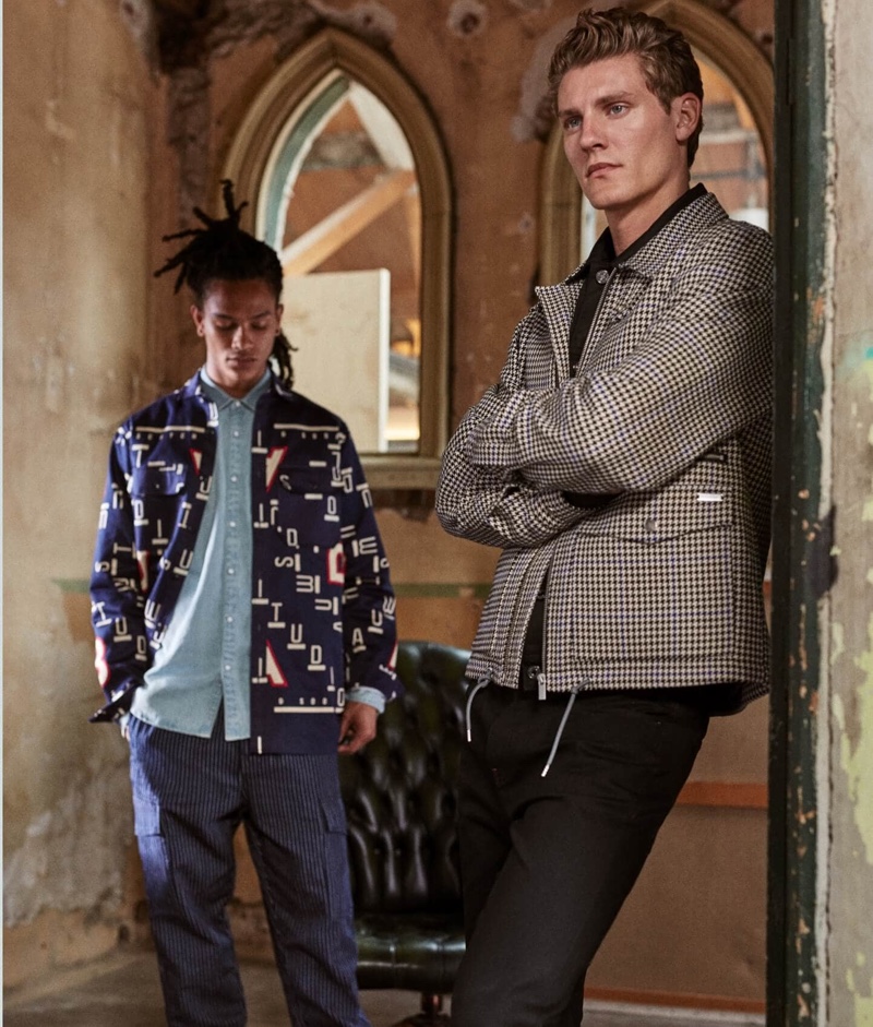 Olajuwon Anderson and Mikkel Jensen wear new season styles from Scotch & Soda. Pictured left, Olajuwon sports a pair of the brand's statement striped cargo pants. Meanwhile, Mikkel dons a houndstooth jacket.