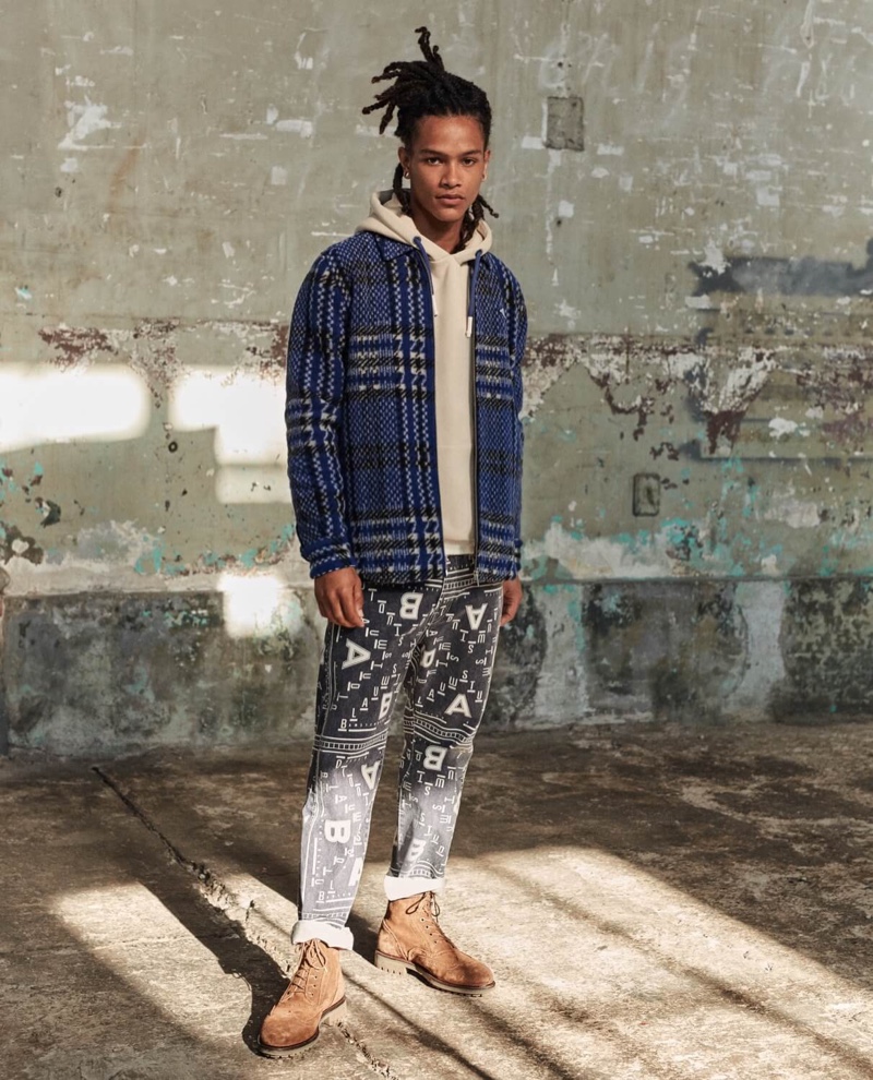 Mixing prints, Olajuwon Anderson wears a Scotch & Soda brushed wool blend jacket and bandana print pants.