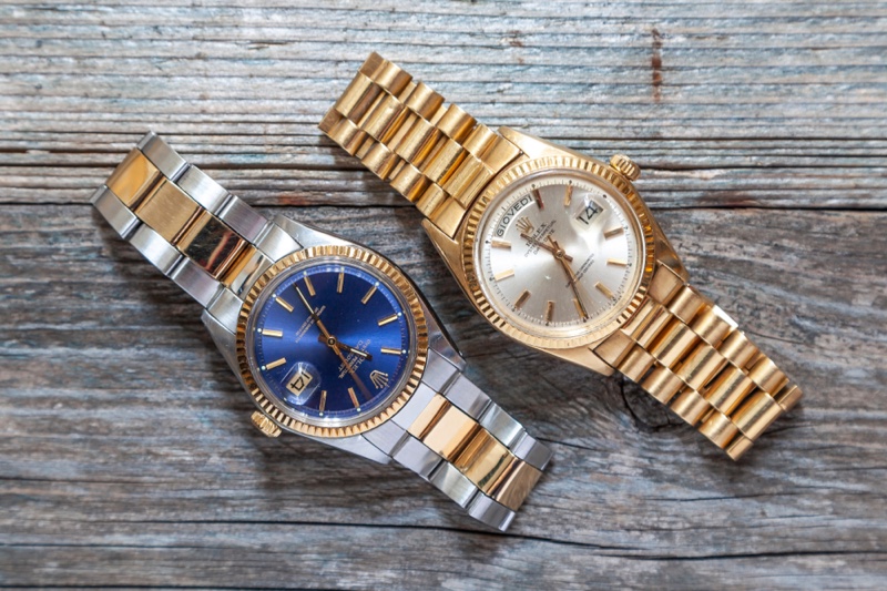 Silver Gold Rolex Watches Wood Backdrop