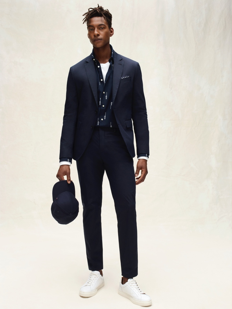 Ty Ogunkoya dons a sleek navy suit from Tommy Hilfiger Tailored's spring-summer 2020 collection.