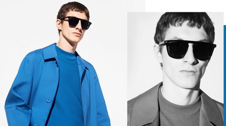 Embracing monochromatic style, Henry Kitcher wears a blue short-sleeve sweater and coat from BOSS.